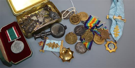 A collection of military medals and cap badges